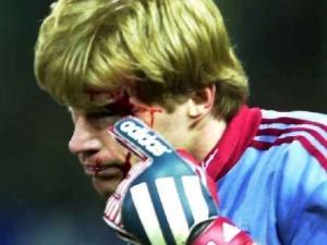 Bayern Münih'in eski kalecisi Oliver Kahn 2000'de Freiburg ile oynadıkları maçta kafasına isabet eden golf topuyla yerde kalıyor.