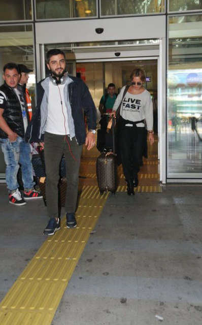 Oldukça neşeli olduğu görülen, basın mensuplarıyla şakalaşan Erken'in kendi valizini kendisinin taşıması dikkatlerden kaçmadı.
