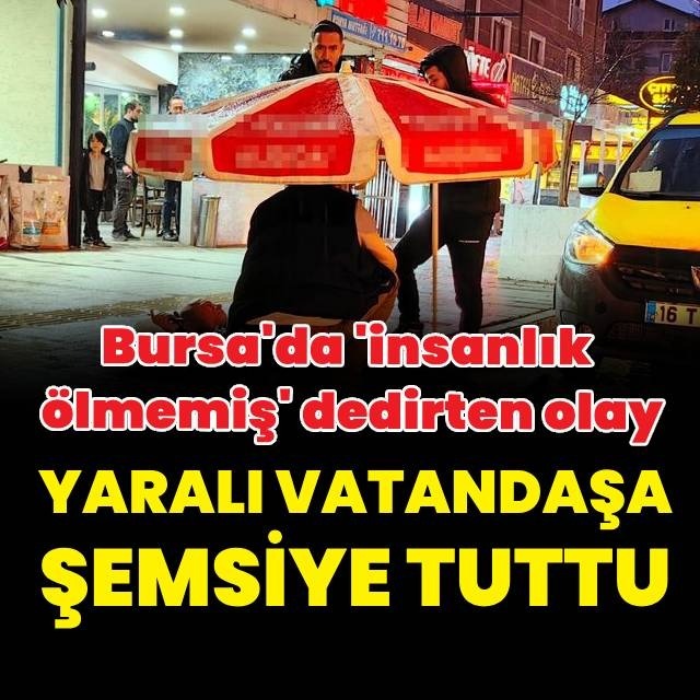 Yaralı yayaya şemsiye tuttu