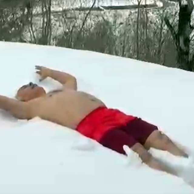 Evinin önünde kar banyosu yaptı