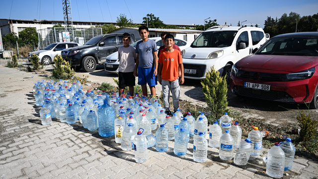 Hatay'daki orman yangınına müdahaleye, konteyner kentteki çocuklardan pet şişeli destek
