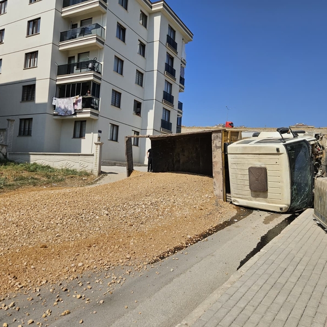 Bursa'da freni boşalan kamyon sitenin duvarına çarparak devrildi