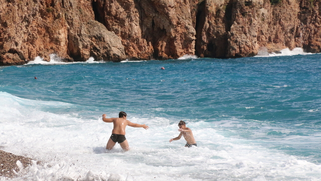 Antalya'da yabancı turistler dalgalara rağmen denize girdi