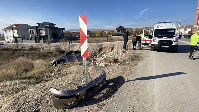 Yoldan çıkan otomobil taşlık alanda asılı kaldı