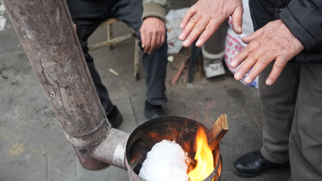 Erzincan pazarcısı soğukta sobayla ısınıyor