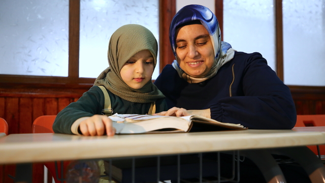 Çevresini silüet olarak gören kadın, yediden yetmişe Kur'an-ı Kerim öğretiyor