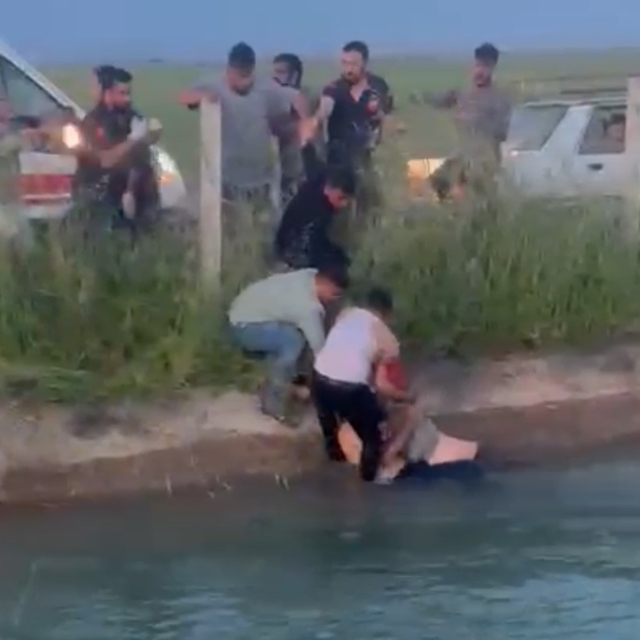 Şanlıurfa'da kanala devrilen otomobildekilere yardım için suya giren Suriye...